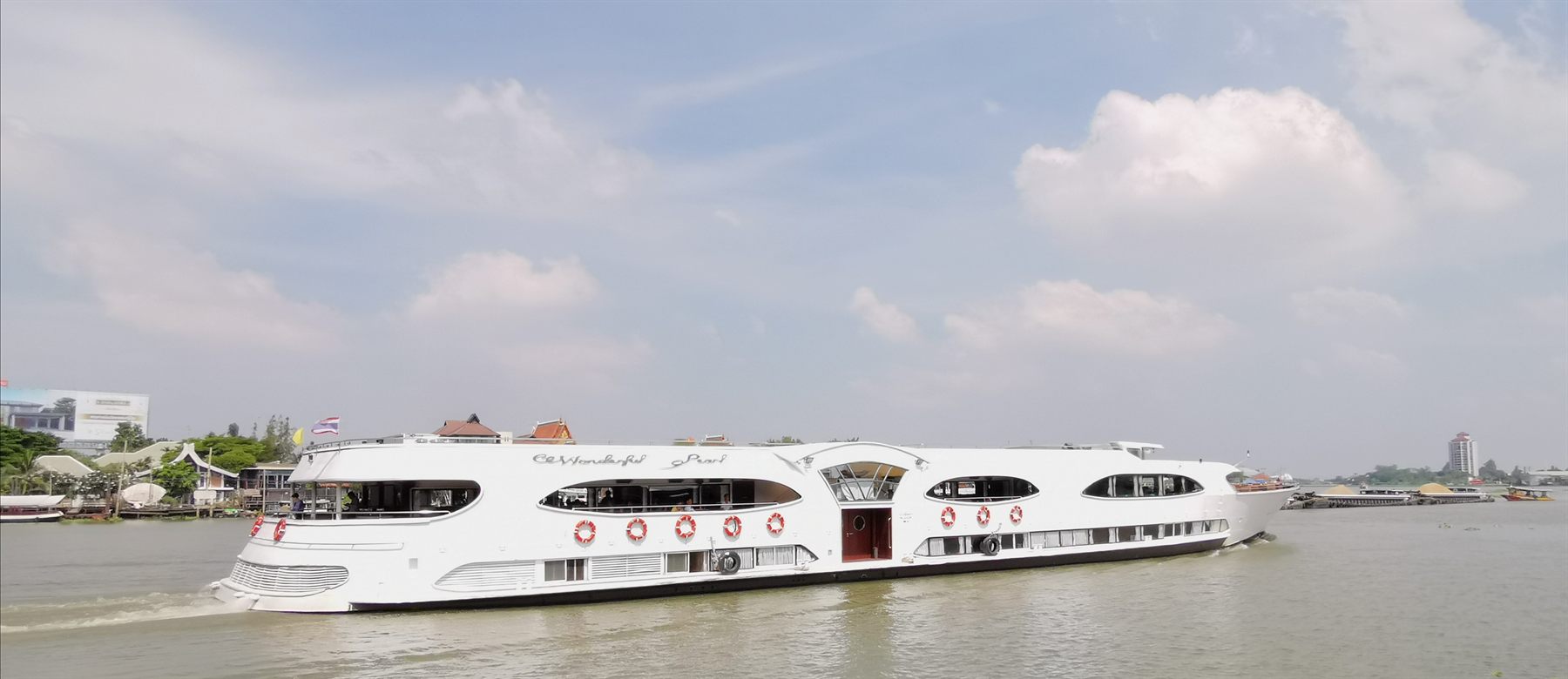 Sleek white river cruise boat on the Chao Phraya River, Thailand
